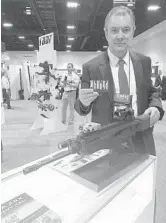  ?? TAMARA LUSH/AP ?? Gabriele de Plano, vice president of BDT marketing and operations of Beretta, displays a prototype of a rifle during the Special Operations Forces Industry Conference in Tampa.