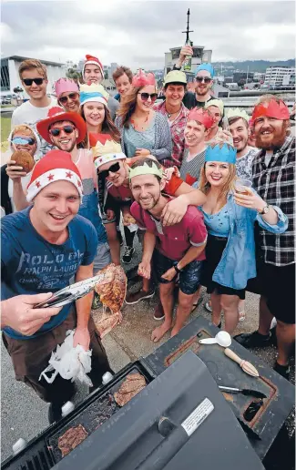  ?? Photo: CAMERON BURNELL/FAIRFAX NZ ?? Cook up: Tourists get into the New Zealand-style festive season with a traditiona­l Kiwi barbecue at Oriental Bay. Anthony Bush, from England, mans the grill.