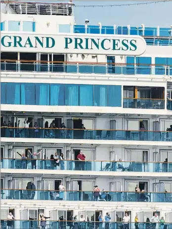  ??  ?? GRAND PRINCESS passengers celebrate as the ship arrives in Oakland on March 9. The vessel, which had 2,500 passengers besides crew members, carried many people who tested positive for the coronaviru­s.