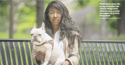  ?? ANTHONY VAZQUEZ/SUN-TIMES FILE ?? Nikkita Brown, shown with her dog, Blanco, has sued a former Chicago police officer for using excessive force against her at North Avenue Beach.