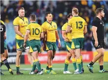  ?? AFP ?? Australian players look dejected after losing their Rugby Championsh­ip Bledisloe Cup match against New Zealand in Sydney last week.