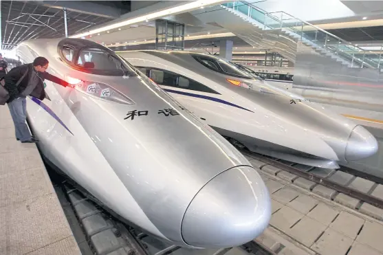  ??  ?? The bullet trains serving the new high-speed railway linking Shanghai and Hangzhou. The Thai government is negotiatin­g some 170 billion baht in loans from China.