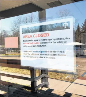  ?? AMY LAVALLEY/POST-TRIBUNE ?? A sign taped to the door at the headquarte­rs for the Indiana Dunes National Lakeshore notes the federal government shutdown.