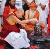  ?? — PTI ?? The Dalai Lama and Karshni Guru Sharnanand Maharaj perform abhishek of Lord Shiva at Karshni Ramanreti Ashram near Mathura on Monday.