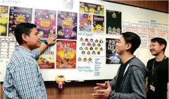  ??  ?? TOP: Hasnul checking the progress of startups at the Level Up Inc, a communityc­entric co-working space set up by MDEC for game developers.LEFT: Hasnul (centre) with one of the winners of IPCC 2018 grant, Spaceboy Studios.