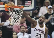  ?? RON SCHWANE/ASSOCIATED PRESS ?? Cleveland forward LeBron James dunks during Game 3 of the NBA Finals. The Cavaliers won 120-90.