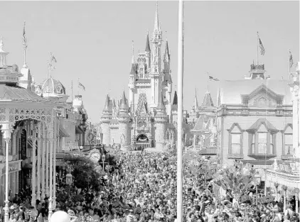  ?? STAFF FILE PHOTO ?? Magic Kingdom, above, and other Disney parks continue to draw crowds. The company reports that its theme parks and resorts division’s revenue jumped 13 percent to $4.9 billion in the second quarter. U.S. theme-park attendance rose 5 percent, Disney said.