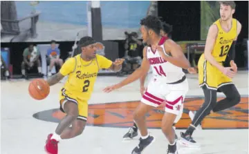  ?? (Photos: Paul Reid) ?? UMBC’S point guard Darnell Rogers (left) takes on Nicholl State University’s Lorenzo Mcghee in their Jersey Mike’s Jamaica Classic NCAA Men’s Division One basketball tournament game at Montego Bay Convention Centre recently.