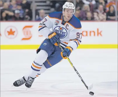  ?? CP PHOTO ?? Edmonton Oilers’ Connor McDavid skates with the puck during first period NHL action against the Vancouver Canucks in Vancouver, B.C. on April 8.