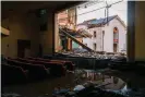  ?? ?? Debris is seen from the inside of the American Legion theatre on 19 December 2021 in Mayfield, Kentucky. Photograph: Brandon Bell/Getty Images