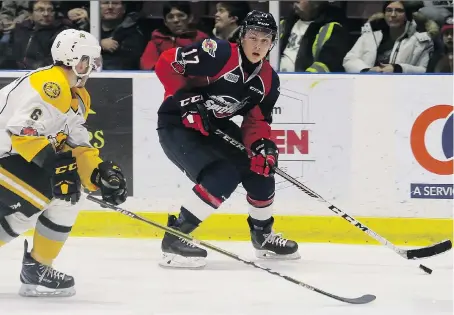  ?? MARK MALONE ?? The Spitfires’ Igor Larionov is chased by the Sarnia Sting’s Braden Henderson at Progressiv­e Auto Sales Arena in Sarnia on Thursday night. The Spitfires defeated the Sting 5-0.