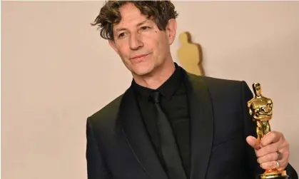  ?? ?? Jonathan Glazer with the Oscar he won for best internatio­nal film for The Zone of Interest. Photograph: Robyn Beck/AFP/Getty Images