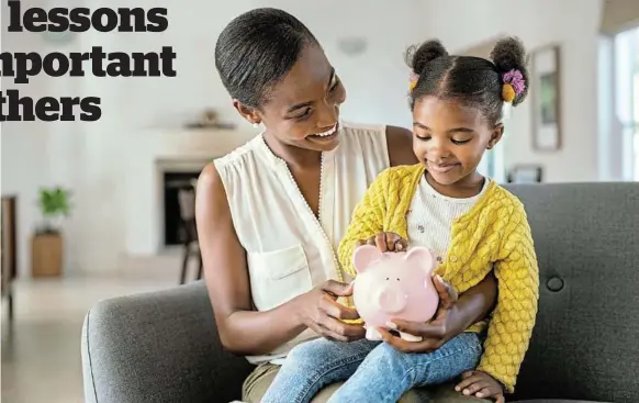  ?? /FRANCESCOR­IDOLFI.COM ?? A devoted young mother teaches her cute little girl some money-saving habits by showing her how to put money away in a piggy bank for future use.