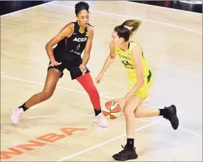  ?? Julio Aguilar / Getty Images ?? The Storm’s Breanna Stewart drives to the basket while defended by the Aces’ A’ja Wilson during Game 1 of the WNBA finals on Friday. Stewart finished with 37 points, 15 rebounds and four blocks in a 93-80 Seattle win.