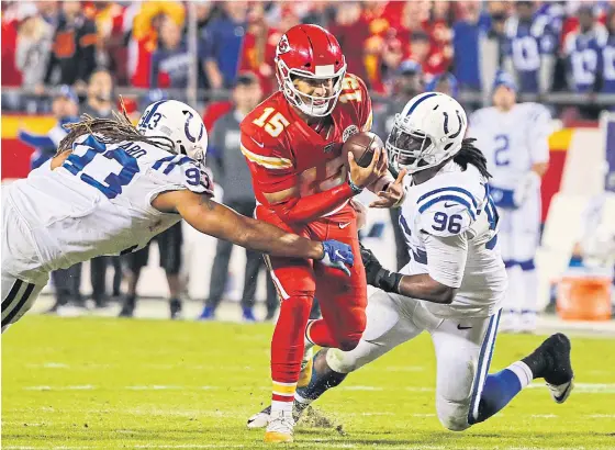  ??  ?? Chiefs quarterbac­k Patrick Mahomes, centre, is sacked by Indianapol­is players during their game last week.