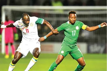 ??  ?? Ogenyi Onazi holds off Cheikh N’doye of Senegal during a recent internatio­nal friendly. The Turkey-based Super Eagles’ vice captain is looking forward to the friendlies ahead of the Russia 2018 World Cup.
PHOTO: AFP.