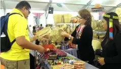  ??  ?? Meron from Murum and Dapong from Baleh showcase their handicraft to visitors.