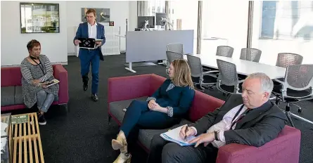  ?? ROSS GIBLIN/STUFF ?? Wellington mayor elect Andy Foster in his Terrace office with, seated from left, Wellington City Council’s head of governance Anusha Guler, legal adviser Hayley Evans, and chief executive Kevin Lavery.