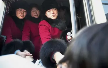  ??  ?? Last goodbye: North Korean women’s hockey team players shaking hands with their South Korean teammates as they return to North Korea at Olympic Village in Gangneung, South Korea. — AP