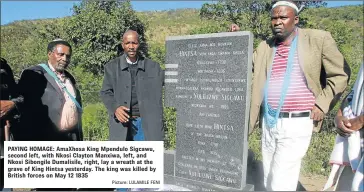  ?? Picture: LULAMILE FENI ?? PAYING HOMAGE: AmaXhosa King Mpendulo Sigcawu, second left, with Nkosi Clayton Manxiwa, left, and Nkosi Sibongile Dumalisile, right, lay a wreath at the grave of King Hintsa yesterday. The king was killed by British forces on May 12 1835