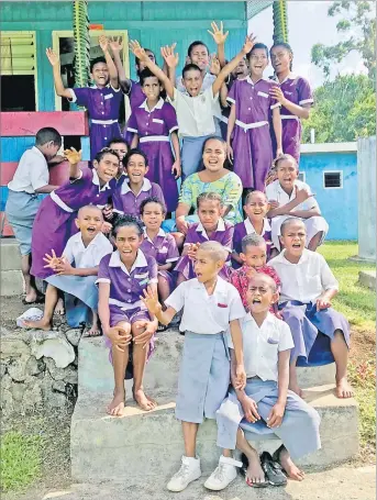  ?? Picture: LITIA CAVA ?? Students and a teacher of Yanuca Island School pose for a photo shoot outside a classroom.