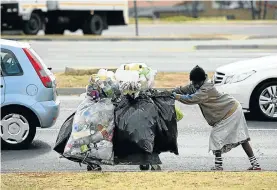  ?? Picture: Antonio Muchave ?? On the wealthy streets of Sandton, an Alexandra township mother collects garbage and plastic bottles for recycling as a means to support her children.