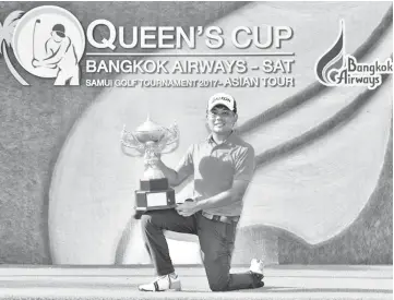  ?? - AFP photo ?? This handout from the Asian Tour shows Nicholas Fung of Malaysia posing with the winner’s trophy after the final round of the Queen’s Cup golf tournament at Santiburi Samui Country Club in Koh Samui June 18, 2017.