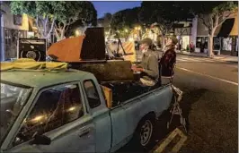  ?? Allen J. Schaben Los Angeles Times ?? DARRYL MAPP, left, and Joe Cardinal take their act on the road — parked in front of a restaurant on Main Street in Seal Beach — via a 1978 Datsun pickup.