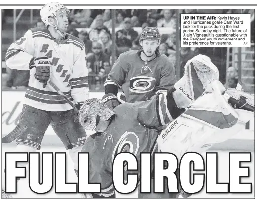  ?? AP ?? UP IN THE AIR: Kevin Hayes and Hurricanes goalie Cam Ward look for the puck during the first period Saturday night. The future of Alain Vigneault is questionab­le with the Rangers’ youth movement and his preference for veterans.