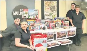  ??  ?? Staff at Elior on Catherine Street with donations: Chef manager Krista Tagell (front), Ron Downes, Julie Cavender and Jean Van Zyl
