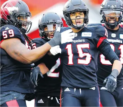  ?? LEAH HENNEL / POSTMEDIA NEWS ?? Calgary’s Eric Rogers, centre, celebrates one of three touchdowns in last week’s 22-14 win over Winnipeg. The last time Rogers played in a Grey Cup Game was in 2014 when he helped the Stamps beat the Hamilton Tiger-Cats 20-16.