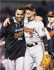  ?? Paul Sancya / Associated Press ?? The Orioles' Nelson Cruz and Ryan Flaherty (3) exult after Baltimore trimmed the Tigers 2-1 to sweep the ALDS.