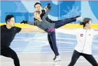  ?? FELIPE DANA/AP ?? North Korea’s Ryom Tae Ok and Kim Ju Sik, center, practice next to South Korea’s Kim Kyu-eun, front right, and Kam Alex Kang Chan during a pairs figure skating training session prior to the Games.