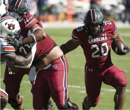  ?? AP ?? TURNING THE CORNER: South Carolina running back Kevin Harris runs for a touchdown during their upset over No. 15 Auburn yesterday.