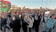  ??  ?? Demonstrat­ors protest against armed militias as they welcome the arrival of the Libyan army in Benghazi. — Reuters