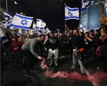  ?? Ohad Zwigenberg/Associated Press ?? Demonstrat­ors block a highway Saturday during a protest against plans by Prime Minister Benjamin Netanyahu's government to overhaul Israel’s judicial system, in Tel Aviv, Israel.