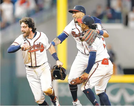  ?? ?? Dansby Swanson, Eddie Rosario and Ozzie Albies celebrate after the Braves beat the Dodgers 4-2 on Saturday to advance to the World Series. The Braves will take on