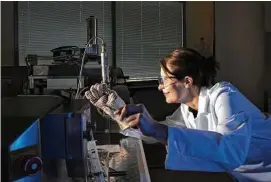  ?? Melissa Lyttle / The New York Times ?? Odile Madden, a plastics conservati­on scientist, pulls a filament of cellulose acetate from an extruder at the Getty Conservati­on Institute. She said scientific analysis is accompanie­d by research.