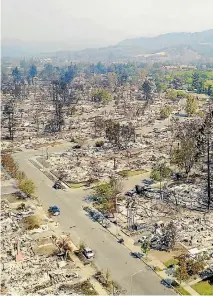  ?? PHOTOS: REUTERS ?? Firefighte­rs work, left, to contain the Tubbs wildfire outside Calistoga, California, while an aerial photo shows the damage in Santa Rosa. The infernos burning across the region are now the state’s deadliest wildfires on record.