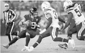  ?? PHELAN M. EBENHACK/AP ?? Jacksonvil­le Jaguars quarterbac­k Gardner Minshew, left, looks to pass under pressure from Los Angeles Chargers free safety Derwin James, center, and defensive end Melvin Ingram, right, Sunday in Jacksonvil­le.