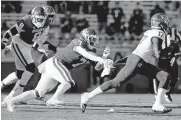  ?? [BRYAN TERRY/ THE OKLAHOMAN] ?? Oklahoma's Ronnie Perkins (7) chases Kansas' Jalon Daniels during Saturday's game in Norman. The Sooners' defense — especially its pressure up front — has played a big part in OU being among the nation's best in drawing penalties from opponents.