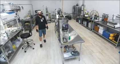  ?? The Maui News / MATTHEW THAYER photos ?? Maui Grown Therapies Director of Product Developmen­t Christophe­r Cole works in the facility’s lab on the afternoon of July 10. POT DISPENSARY SHOWS OFF NEW LAB