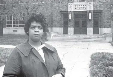  ?? AP FILE PHOTO ?? Linda Smith, formerly Linda Brown, stands in front of Sumner School in Topeka, Kansas, on May 8, 1964 — 13 years after the school refused to admit her when she was 9 years old. That refusal led to the Brown v. The Board of Education of Topeka lawsuit, which concluded with the U.S. Supreme Court mandating that schools nationwide must be desegregat­ed.