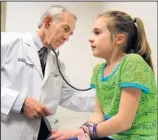  ?? PHIL SKINNER/MCT ?? Dr. Stanley Fineman of the Atlanta Allergy & Asthma Clinic in Marietta, Ga., examines 8-year-old Hannah Claire Brown.