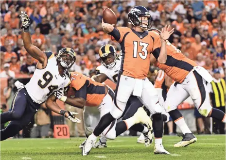  ?? RON CHENOY, USA TODAY SPORTS ?? Trevor Siemian, right, beat out veteran Mark Sanchez and rookie Paxton Lynch for the Broncos’ starting quarterbac­k job.