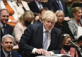  ?? (AP/UK Parliament/Jessica Taylor) ?? British Prime Minister Boris Johnson speaks Wednesday during Prime Minister’s Questions in the House of Commons in London. Johnson said he plans to present his plan for living with the virus when Parliament returns from a break Feb. 21.