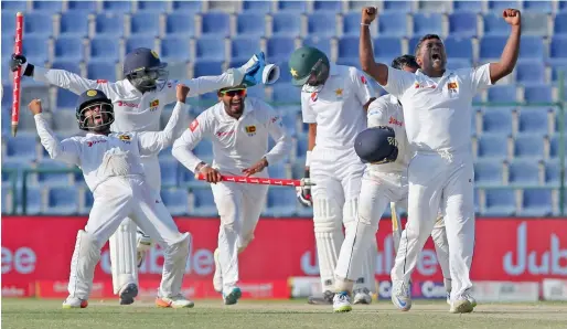  ?? Photo by Ryan Lim ?? Sri Lanka’s Rangana Herath (right) celebrates with teammates after winning the first Test against Pakistan at the Sheikh Zayed Stadium in Abu Dhabi. —