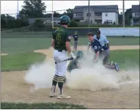  ?? MIKE CABREY — MEDIANEWS GROUP ?? Nor-Gwyn’s Steve Corrado creates a dust cloud after sliding safely into home plate to score during the fourth inning of the Hawks’ 3-0Bux-Mont American Legion victory over Quakertown Wednesday.