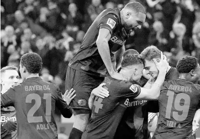  ?? AP ?? Leverkusen’s Josip Stanišić (second right) celebrates with teammates after scoring his side’s opening goal during the German Bundesliga football match against FC Bayern Munich at the BayArena in Leverkusen, Germany, yesterday.