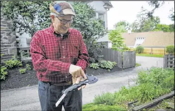  ?? CAMERON B. POLLACK PHOTOS / PHILADELPH­IA INQUIRER ?? Marvin Weinberger points out the features of his tool, the Off-Grid Survival Axe Elite, which include a hacksaw blade and several hex wrenches, at his home office recently in Havertown, Pennsylvan­ia.
